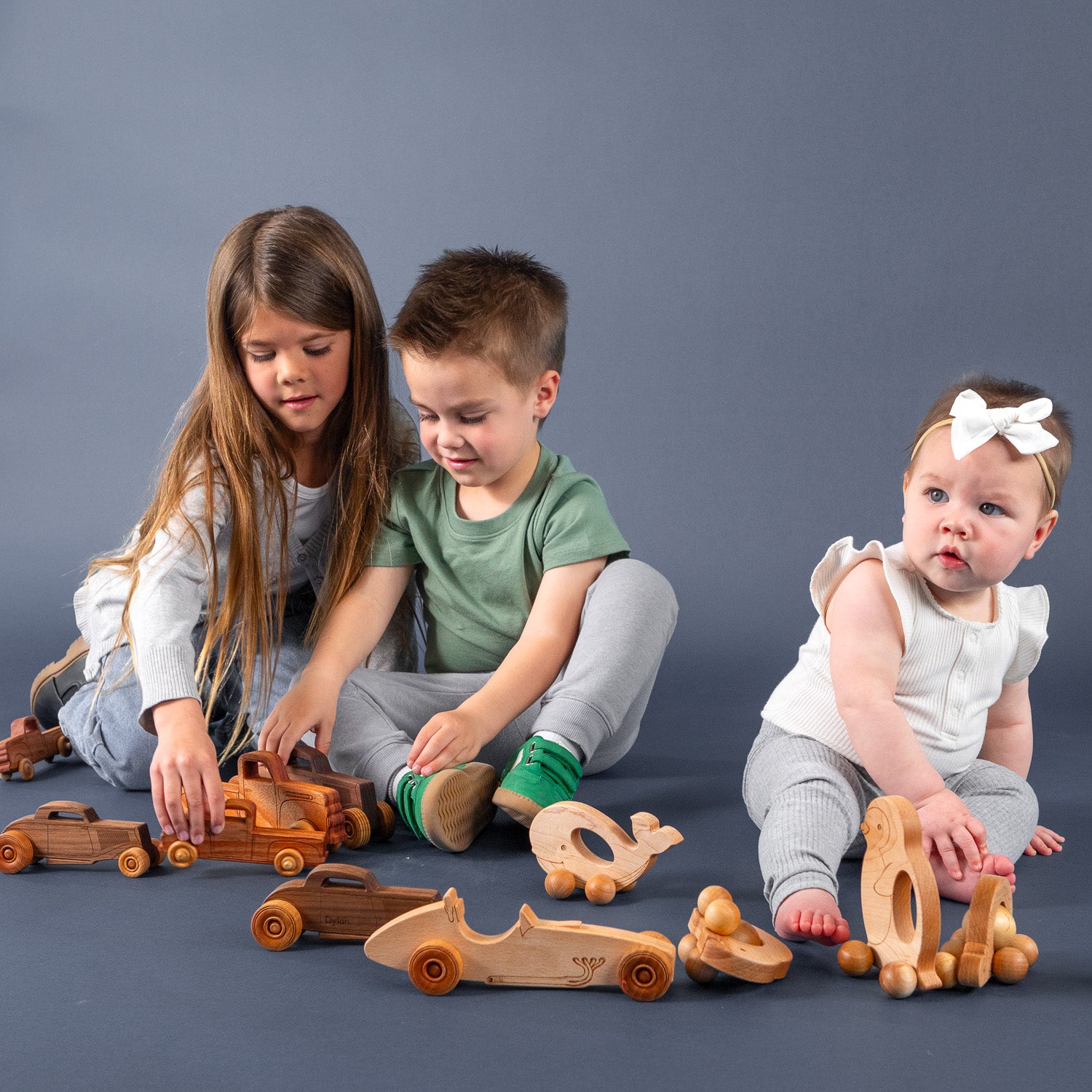 Siblings playing with wooden toys together.