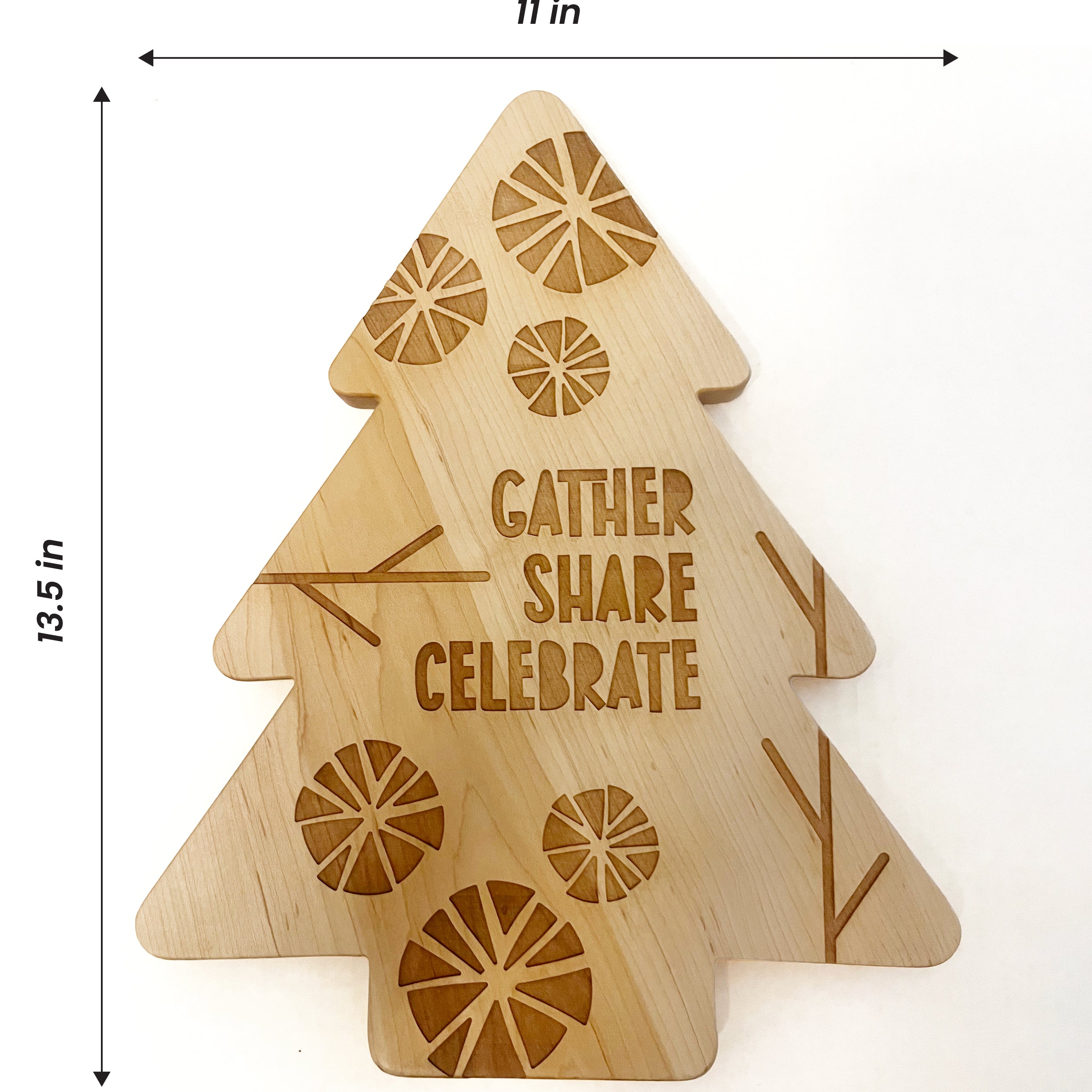 A laser-engraved wooden Christmas tree platter with the words 'GATHER SHARE CELEBRATE' and decorative citrus slice patterns. The image includes dimension lines indicating a height of 13.5" and 11" width
