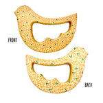 Two bird-shaped baby teething toys shown on a white background, labeled FRONT and BACK. The top toy shows the front side with a yellow-orange dotted pattern and small green dots.