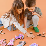 Brother and sister helping each other put together puzzles.