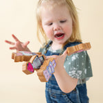 Girl playing with wooden finger puppets.