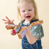 Girl playing with wooden finger puppets.