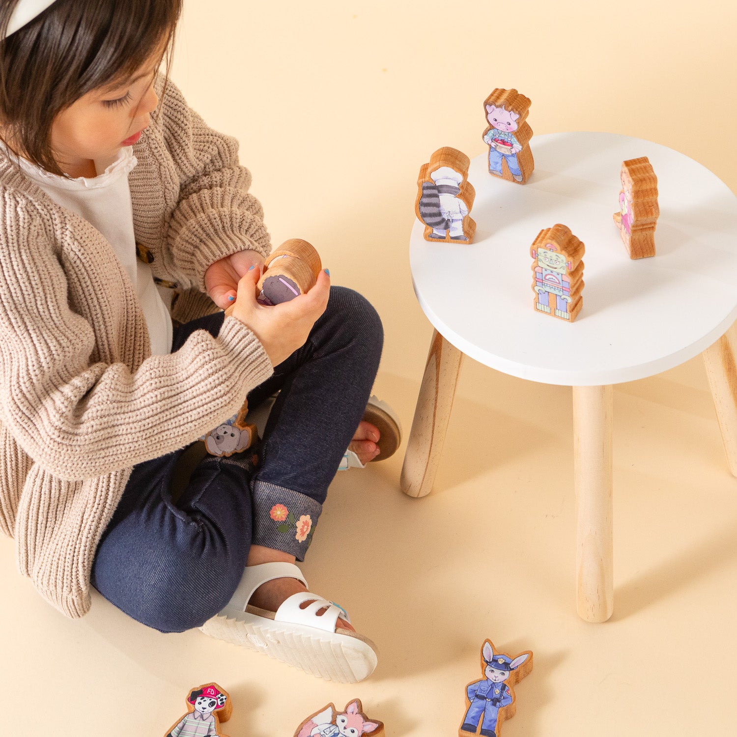 Girl playing with wooden finger puppets.