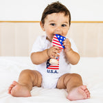 Baby holding a small American flag with 'U.S.A.' text on a white background