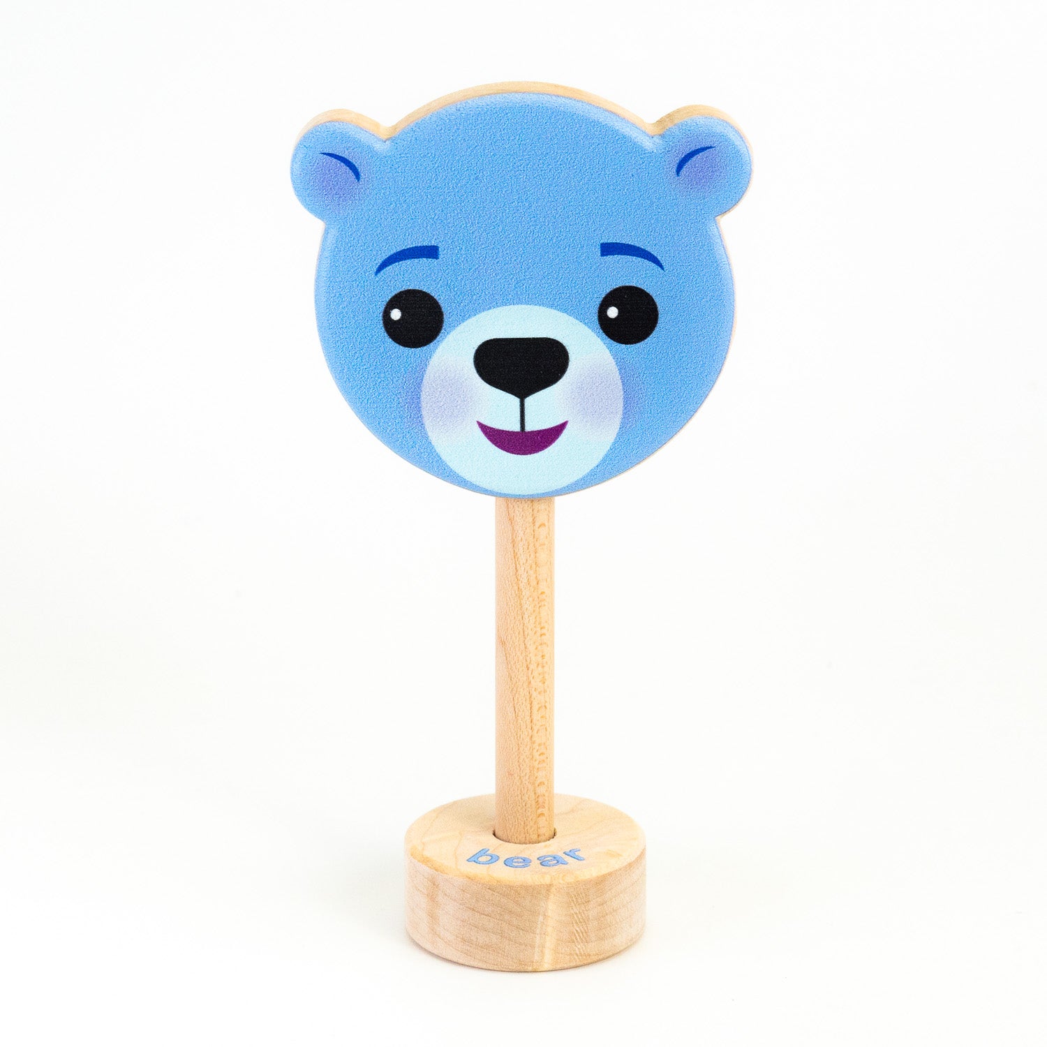 A wooden rattle with a blue bear face, a long wooden dowel for grasping, and a small base with the word "bear" spelled out. 