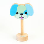 A wooden rattle with a blue dog face, a long wooden dowel for grasping and a small base with the word "dog" spelled out. 