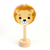 A wooden rattle with a lion face, a long wooden dowel for grasping and a small base with the word "lion" spelled out. 