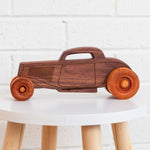 Classic wooden hot rod on a stool.