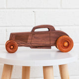 Classic wooden hot rod on a stool.