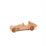 A small handcrafted wooden toy race car with visible wood grain and detailing.