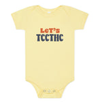 Yellow baby onesie with "Let's Teethe" on it in orange and navy. The "e's" in "teethe" have little teeth.