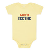 Yellow baby onesie with "Let's Teethe" on it in orange and navy. The "e's" in "teethe" have little teeth.