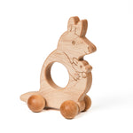 A wooden kangaroo push toy with large textured sphere wheels, designed for babies and toddlers.
