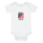 White baby onesie with "Made in the USA" on it in red whte and blue with a small flag.