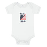 White baby onesie with "Made in the USA" on it in red whte and blue with a small flag.