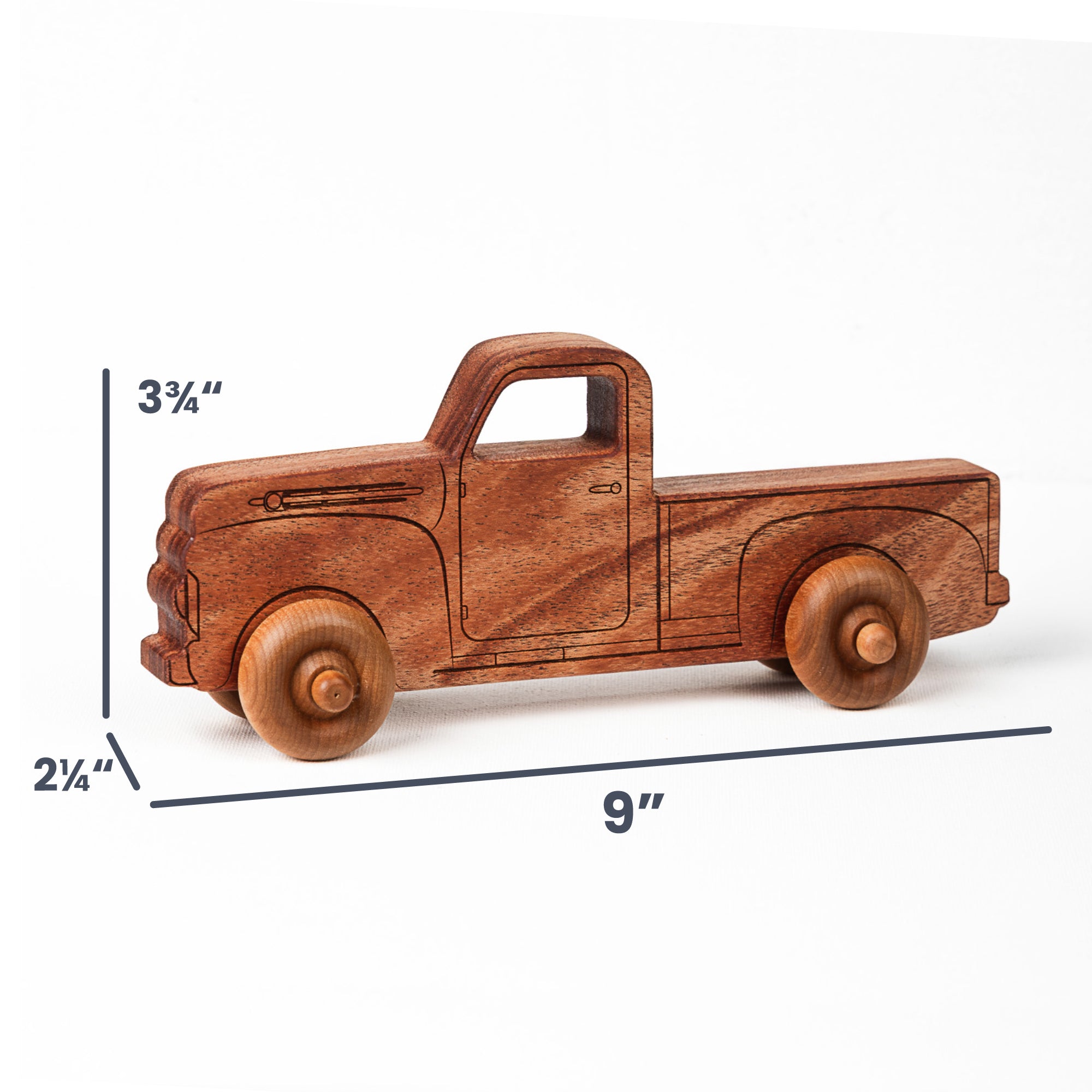A wooden toy pickup truck shown on a white background with dimension lines indicating 9 inches long, 3 3/4 inches tall, and 2 3/4 inches wide.
