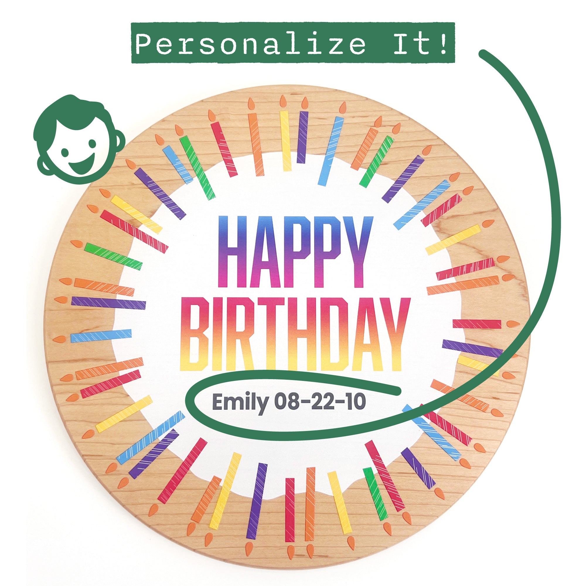 A personalized round wooden birthday board printed on light natural wood, featuring colorful painted birthday candles around the edge and the text 'HAPPY BIRTHDAY' in a rainbow gradient. A green curved line and a small green icon indicate personalization options, including the name 'Emily' and the date '08-22-10'.