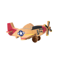 A wooden P-51 Mustang airplane with a pinup "Betty" girl near the propeller.