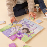 A little girl sitting on the floor putting together a wooden puzzle.