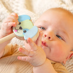 A baby holding a dog rattle. 