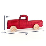 A red wooden toy pickup truck with natural wood wheels, shown on a white background with dimension lines indicating 9 inches long, 3 3/4 inches tall, and 2 1/4 inches wide.