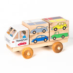 A wooden 3D puzzle truck with various car shapes in different colors loaded on the transport part of the truck.