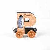 Wooden toy letter 'P' with a penguin illustration on a white background