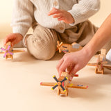 Children playing with wooden airplanes.