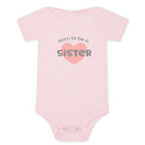 Pink baby onesie with "Born to be a Sister" in grey lettering with a dark pink heart.