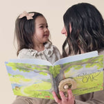 A mom reading The Mighty Oak book to her daughter. 