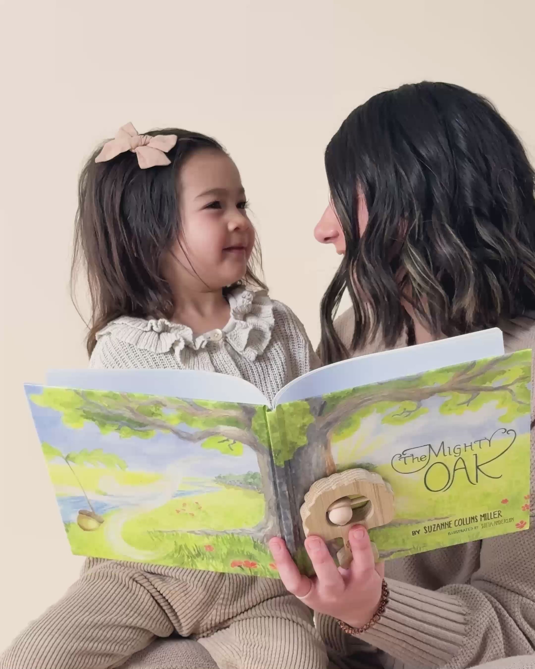 A mom reading The Mighty Oak book to her daughter. 