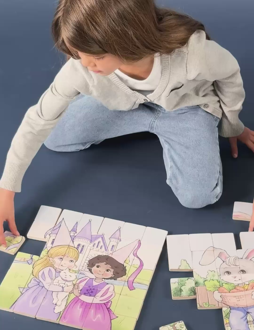 A school age girl add the last piece of the princess magnetic wooden puzzle.