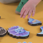 A boy making a puzzle of a triceratops with magnetic pieces.